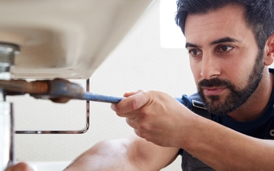 Plumber fixing sink